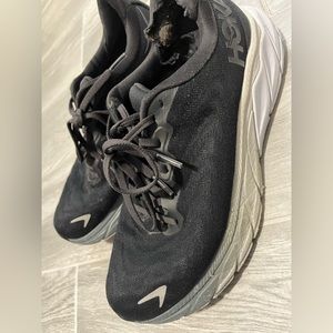 Pre-loved black Hoka tennis shoes.